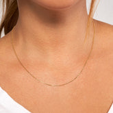 14k Yellow Gold Diamond Cut Cable Chain on woman's neck